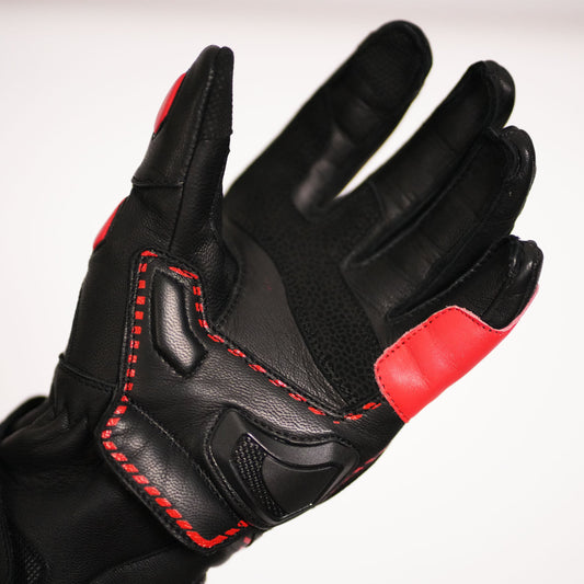 Close-up of the glove's palm area, showing the dedicated scaphoid/heel of hand protector, reinforced leather, and detailed red contrast stitching.