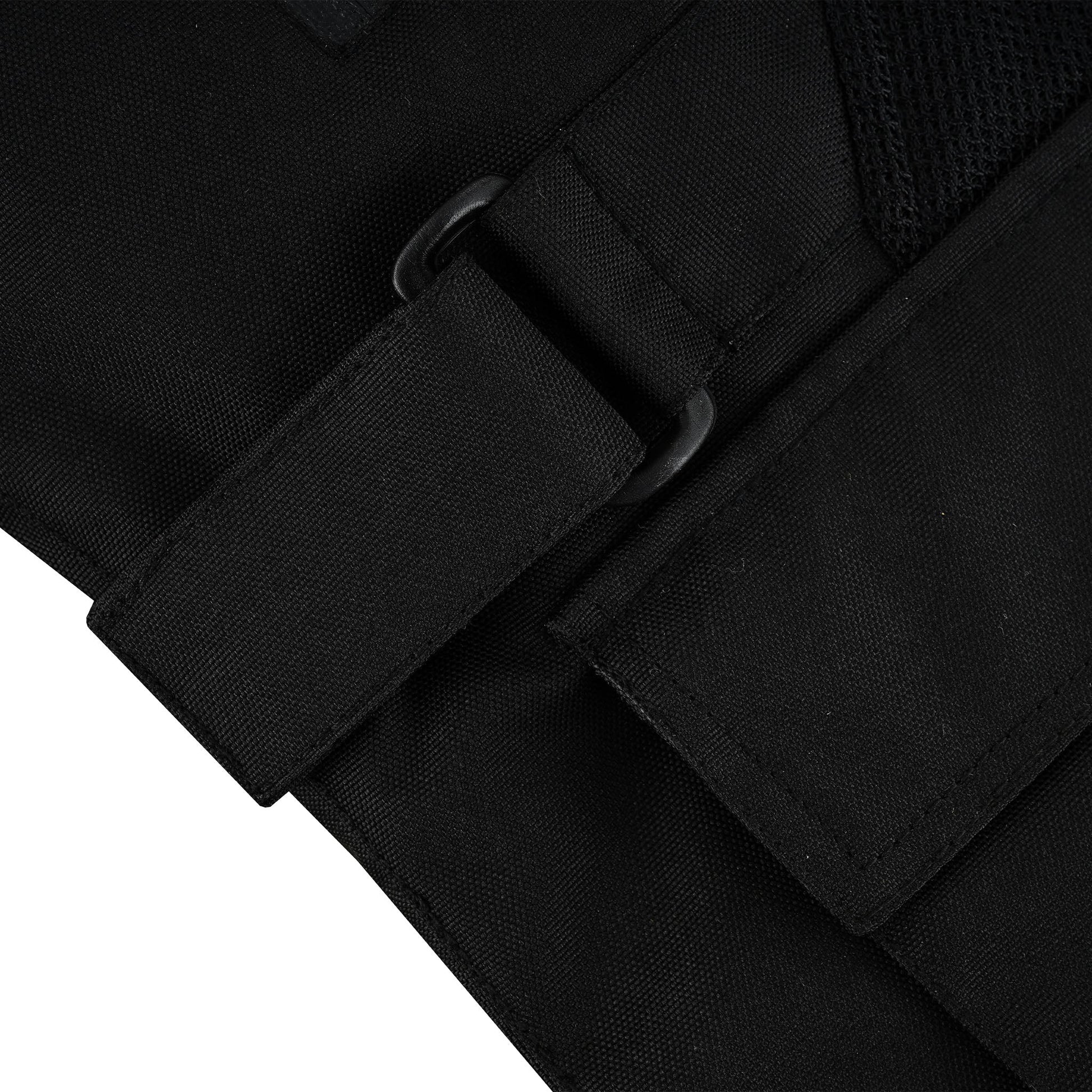 Close-up of the jacket's side, showing a black webbing adjustment strap threaded through a black plastic D-ring or buckle for cinching the waist or hips.