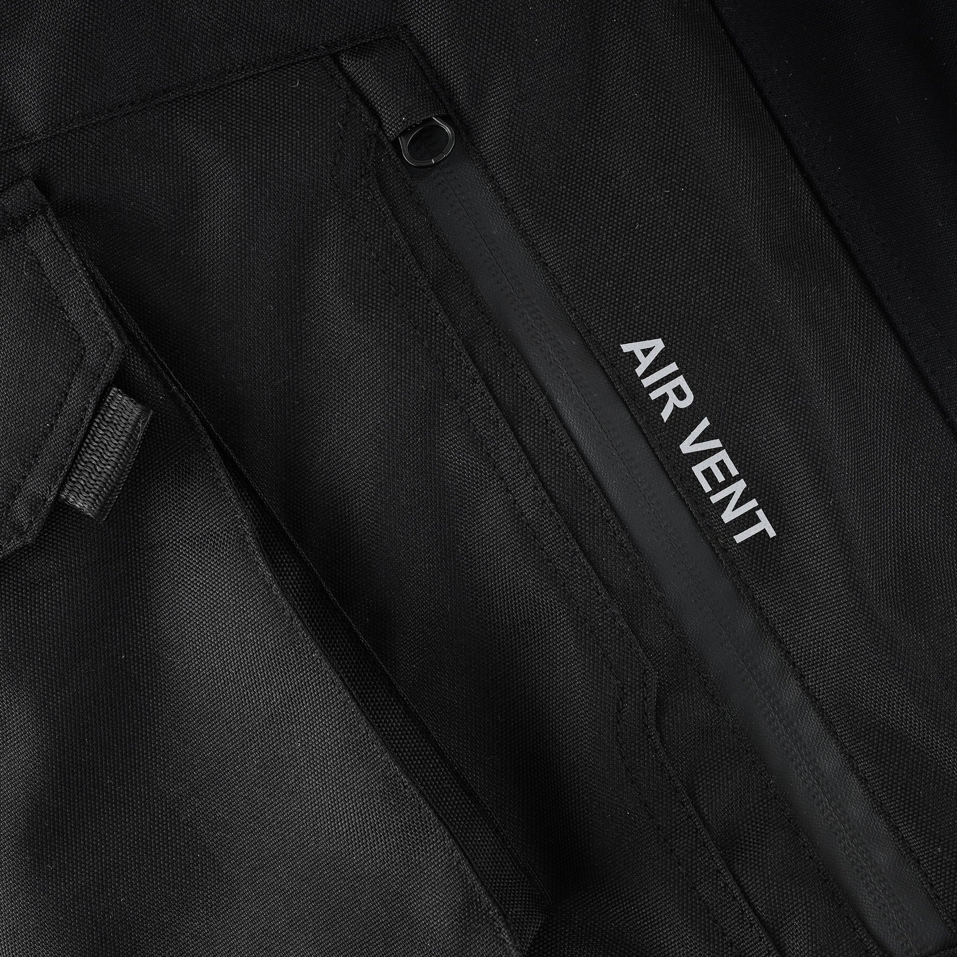 Close-up of the trouser's large cargo pocket, showing the vertically placed zippered opening labeled "AIR VENT" and the pocket's closure flap.