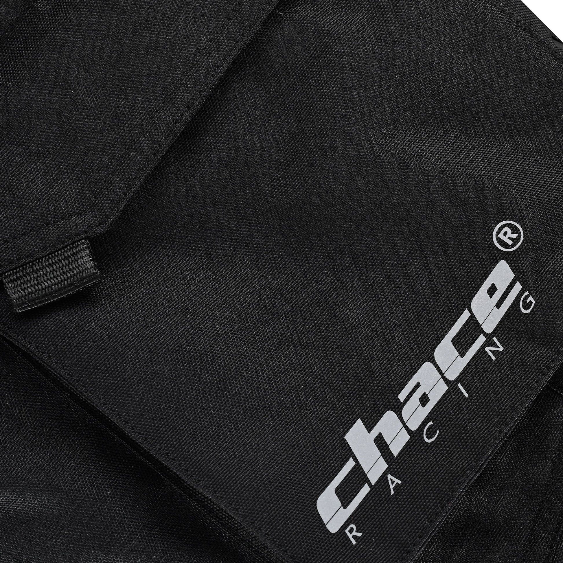 Close-up of the trouser's cargo pocket flap, featuring the stitched white and black "Chace Racing" brand logo patch and the secure fabric pull tab.