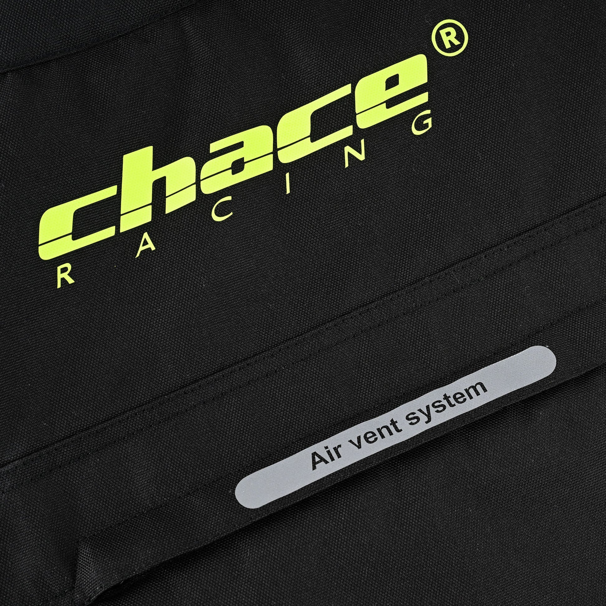 Close-up of the jacket textile, showing the hi-vis yellow "Chace Racing" logo and a separate silver reflective strip labeled "Air vent system".