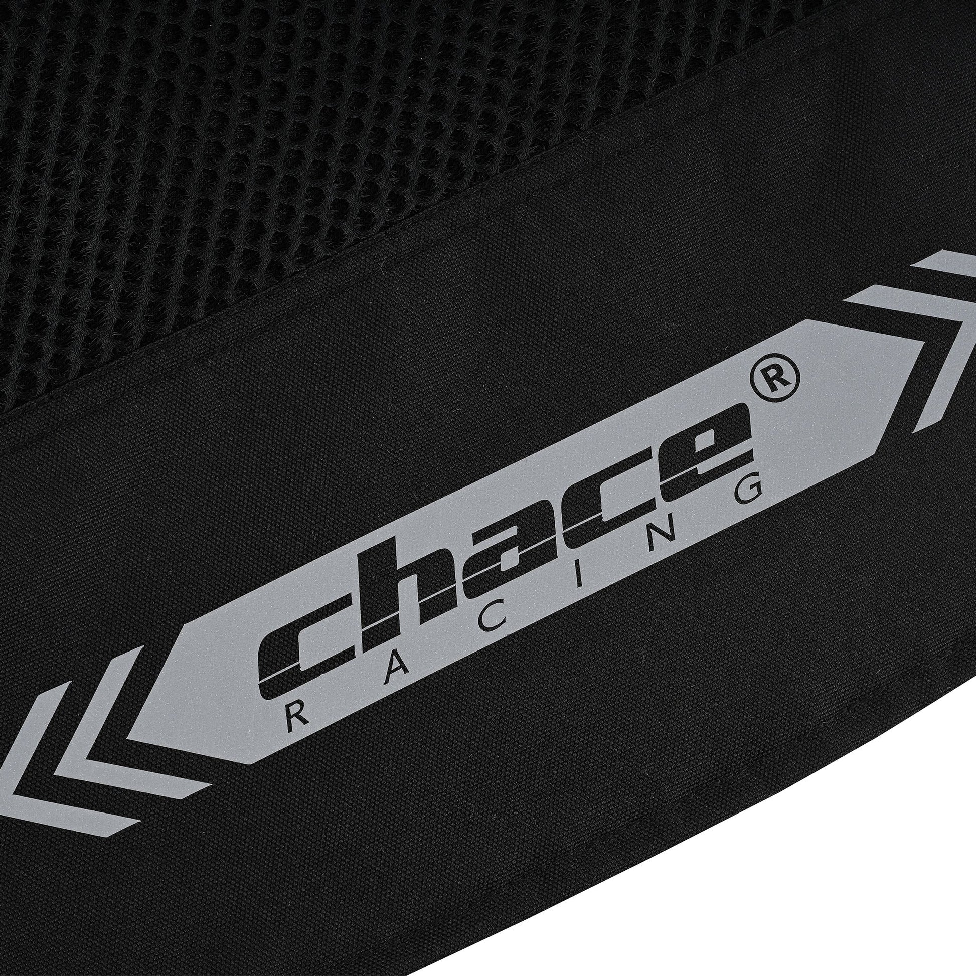 Extreme close-up of the lower back hem branding, showing the large, reflective "Chace Racing" logo flanked by reflective arrow graphics on the black textile.
