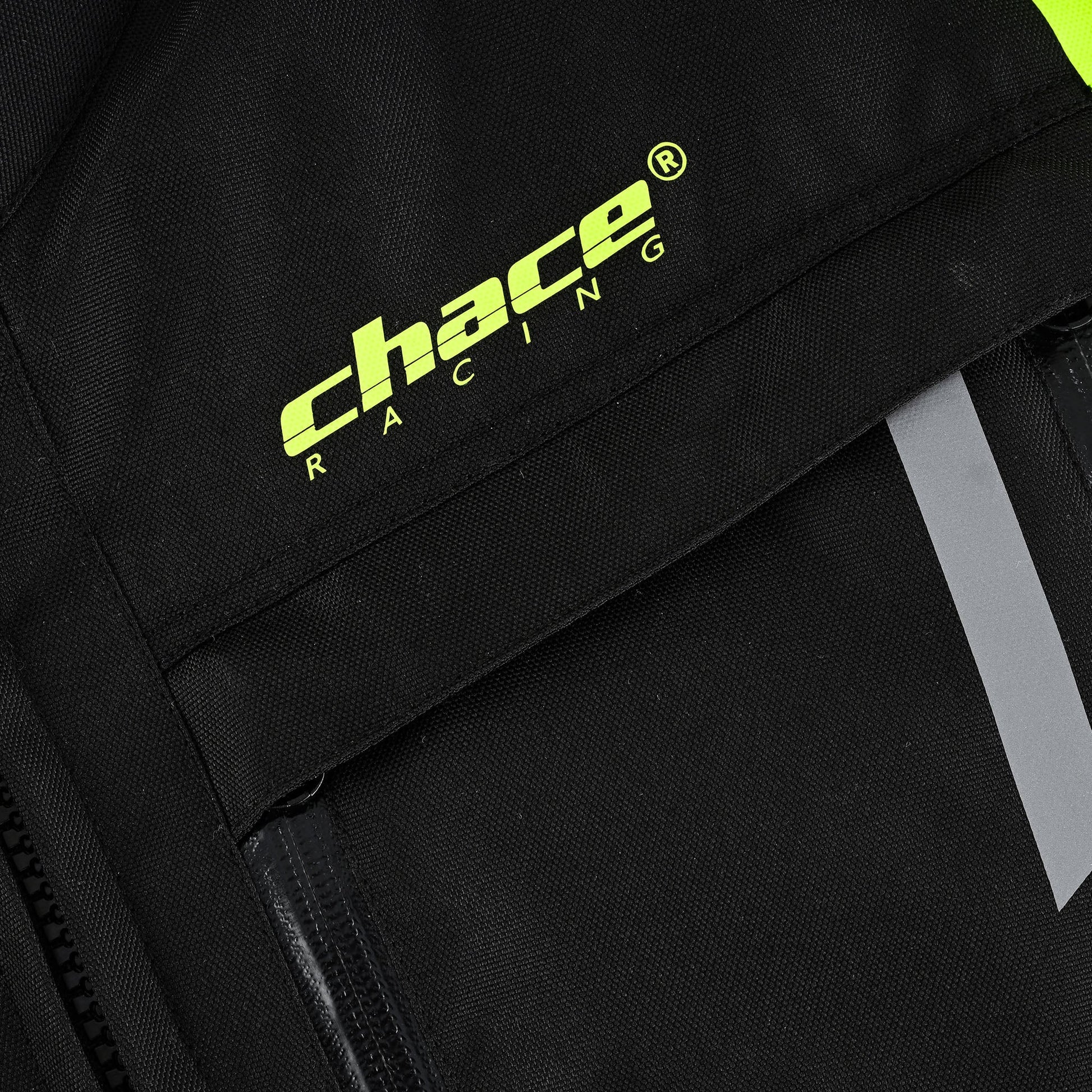 Close-up on the jacket's chest area, featuring the hi-vis yellow "Chace Racing" logo printed prominently above a front flap pocket.
