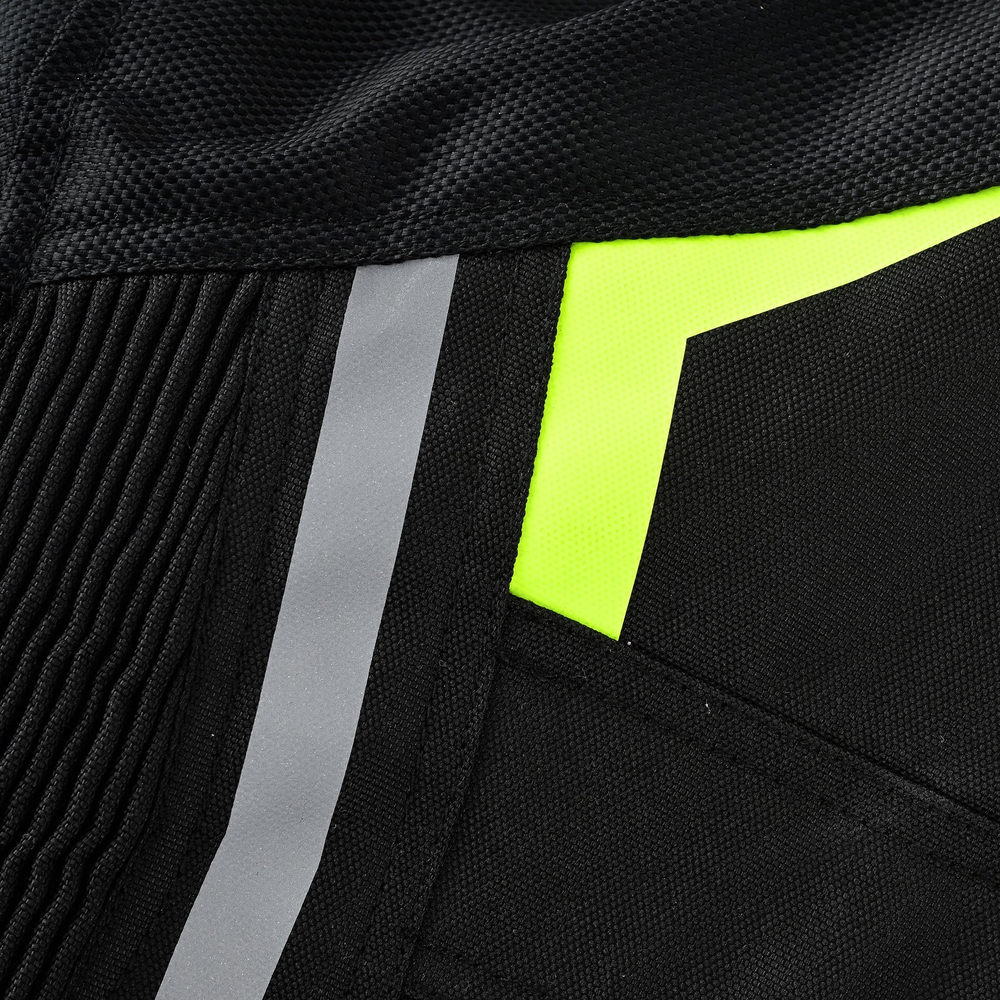 Close-up showing the combination of black stretch accordion textile, a silver reflective stripe, and a bright fluorescent yellow panel for high visibility.
