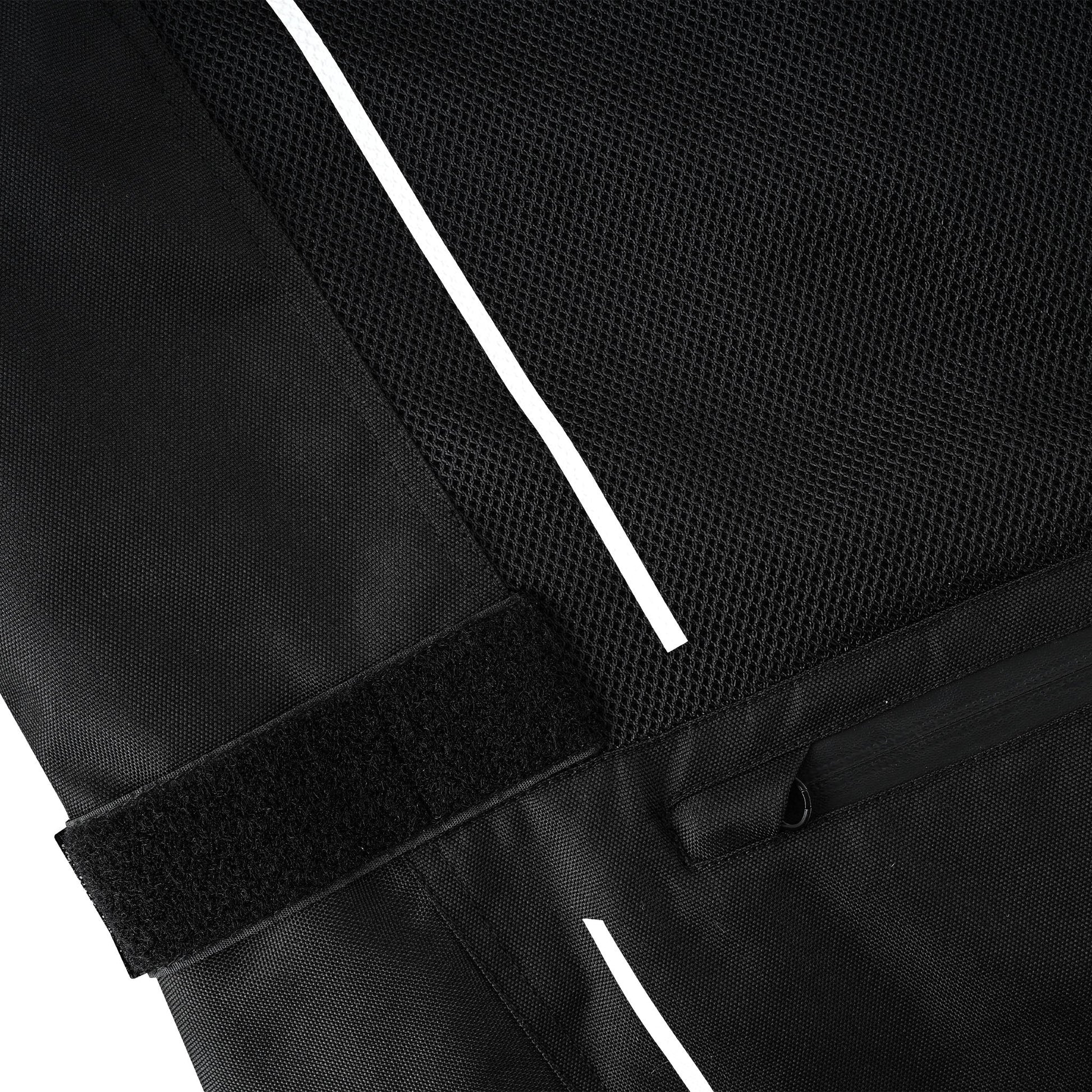 Close-up showing the bright white reflective stripe transitioning between the breathable mesh and the textile fabric, next to a wide black hook-and-loop (Velcro) adjustment strap.