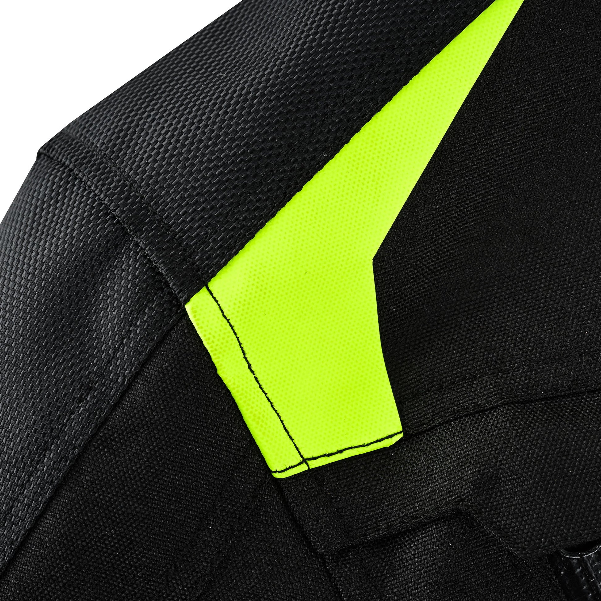 Extreme close-up of the jacket's shoulder, showing a bright, triangular panel of fluorescent hi-visibility yellow textile seamlessly integrated into the black woven fabric.