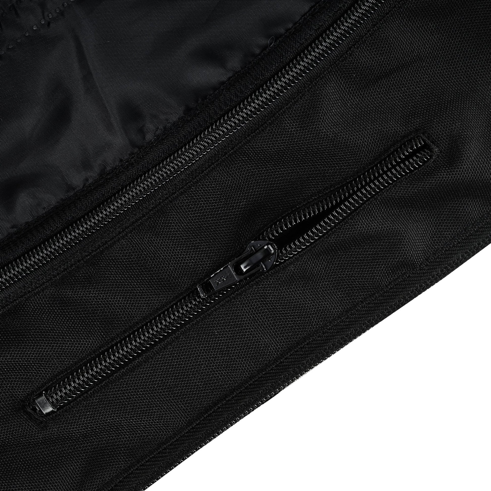 Close-up of a black zippered pocket on the jacket's exterior, showing a durable coil zipper embedded in the textile fabric with a matching pull tab.